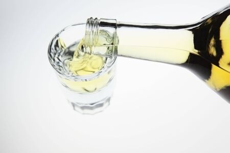 Liquor poured into a shot glass の写真素材