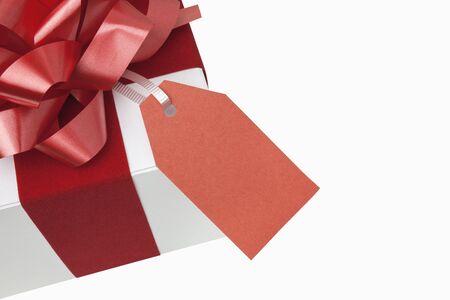 Christmas present with blank gift tagの写真素材