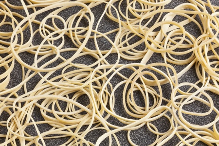 Close-up pile of rubber bands on desktop, studio shot