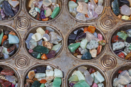 Polished stones in antique metal baking trayの写真素材