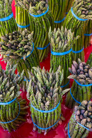 Bunches of fresh asparagus for sale at a farmers market in the Pacific Northwestの写真素材