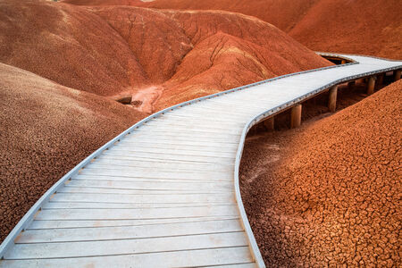 Wooden raised walkway through the Red Hills of the Painted Hills Unit of the John Day Fossil Beds National Monument, Oregonの写真素材