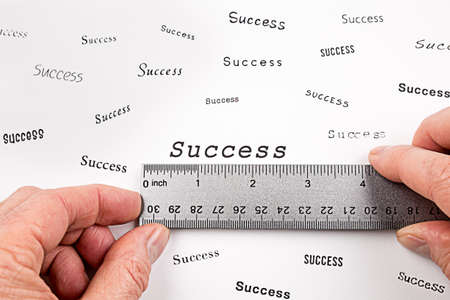 A man measures the word Success with a rulerの写真素材