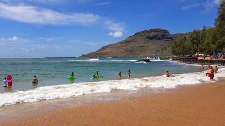 Tourists and locals swim at Kalapaki Beach in the town of Nawiliwili on the island of Kauaiのeditorial素材