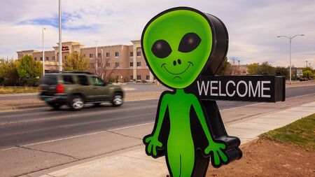 Little green alien and welcome sign welcomes visitors to a business in Roswell, New Mexicoのeditorial素材