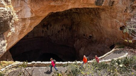 Tourists hike the trail into and out of the Natural Entrance at Carlsbad Caverns National Parkのeditorial素材