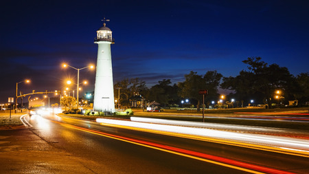 Biloxi lighthouse as night falls with passing automobile traffic in Mississippiの写真素材