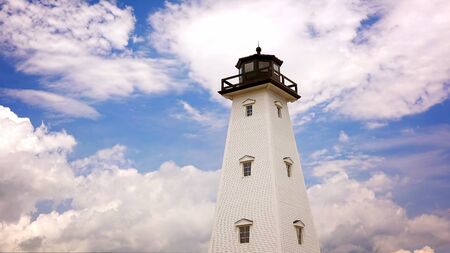 Dreamy lighthouse against cloud filled sky in Gulfport, Mississippiの写真素材