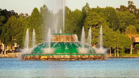 Large water fountain on Lake Eola during daytime in downtown Orlando, Floridaの写真素材