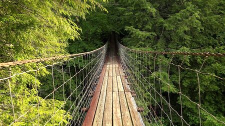 Walking across suspension bridge POV at Fall Creek Falls State Park in Tennesseeの写真素材
