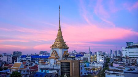 Bangkok skyline at sunset and China Gate at the entrance to Chinatown in Thailand