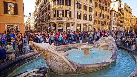 Tourists view water fountain Fontana della Barcaccia at the Piazza di Spagna in Rome, Italyのeditorial素材