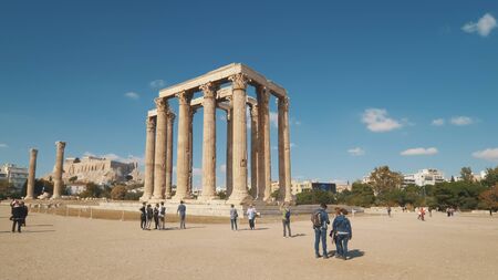 Tourists view the ruins of the Temple of Olympian Zeus in Athens, Greece