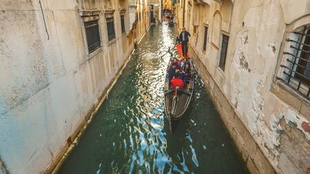 Tourist gondola in narrow side canal in Venice, Italyのeditorial素材