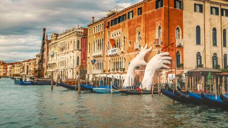The Giant Hands sculpture by Lorenzo Quinn appears to hold up a building along the Grand Canal in Venice, Italy The support shows concern for the effects of climate changeのeditorial素材