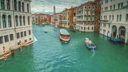 Boats traverse the Grand Canal along amazing city architecture in Venice, Italyの写真素材