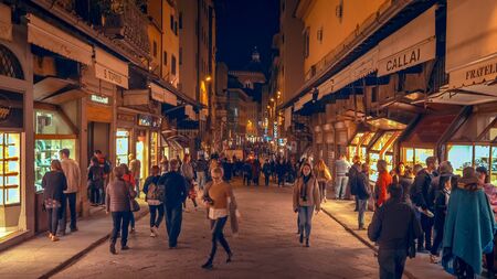 FLORENCE, ITALY - NOVEMBER 12th: People walking on city street in downtown Florence, Italy at night on November 12th, 2017のeditorial素材