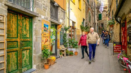 CORNIGLIA, ITALY - NOVEMBER 14th: Tourists walk along a narrow alley in the Cinque Terre village of Corniglia  in the province of La Spezia on November 14th, 2017のeditorial素材
