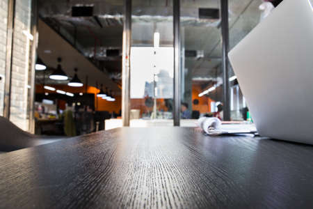 Office table background ideas and business concept. Side view of Wood working table in black wood and computer  laptop with copy space.の写真素材