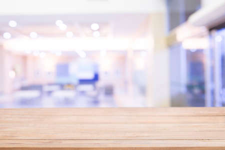 Empty Wood table top with blur hospital with bokeh light at background, Mock up for display or...