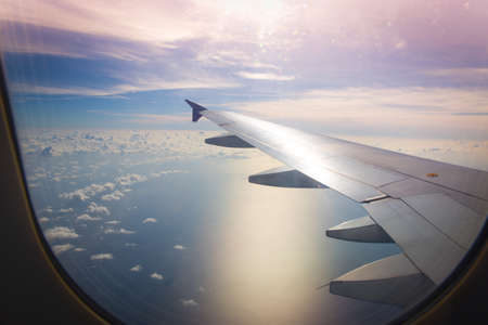Top view with clouds from the aircraft window with the wingの写真素材