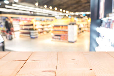 Pine Wood table top on blur with bokeh shopping mall background - can be used for display or montage...