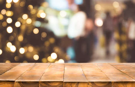 Festive holiday background with empty dark wooden table top over festive bokeh light decorate on tree. For create montage product display.の写真素材