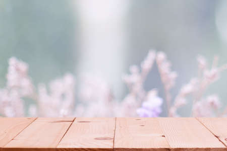 Empty wooden table on defocuced winter window with winter flower background .の写真素材