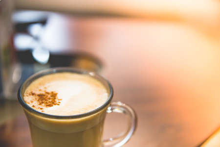 Close up Glass of hot Cappuccino coffee on wood table.の写真素材