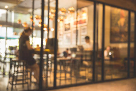 Blurred background  coffee shop or cafe restaurant with abstract bokeh light image. Vintage filter.の写真素材