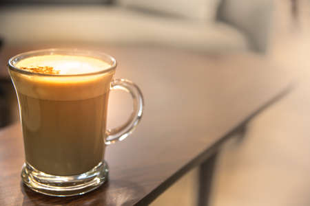 Close up Glass of hot Cappuccino coffee on wood table.の写真素材