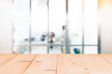 Empty wood table with blur abstract group of business people background. For montage product display or design key visual layout.の写真素材