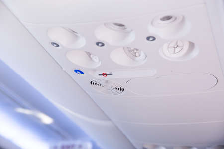 Close up of overhead console in the modern passenger aircraft.air conditioner button and lighting switch.selective focusの写真素材