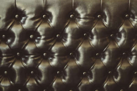 elegant dark brown leather texture with buttons for pattern and background. Vintage filter.の写真素材
