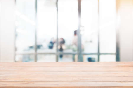 Empty wood table with blur abstract group of business people background. For montage product display or design key visual layout.の写真素材