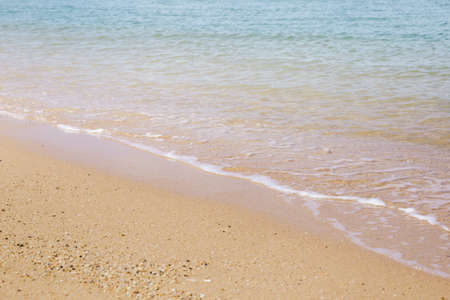 Sand and soft wave at the beach background. Drop space on bottom right for text and other. Copy...