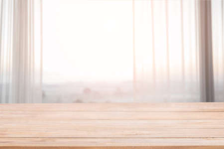 Empty wood and defocused curtain window with morning sunlight and fog in the morning. For montage product display or design key visual layoutの写真素材
