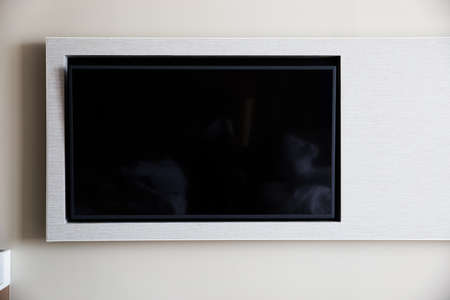 TV on the cabinet in modern living room on white wall background. Copy space.
