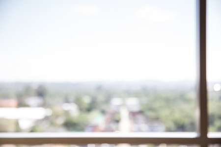 Blur abstract of green view and city in a window frame.の写真素材