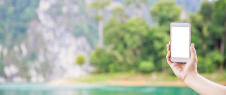 Mock up screen showing on the smartphone with tropical island and mountain background.の写真素材