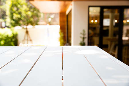 Empty wood white table and blurred cafe or restaurant light background. product display template.Business presentationの写真素材