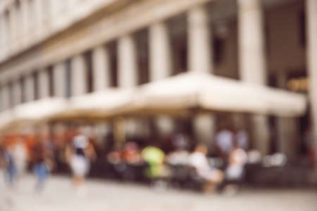 Blurred abstract background of outdoor cafe or restaurant. Outdoor cafe with tables, chairs and barrel outside in town.の写真素材