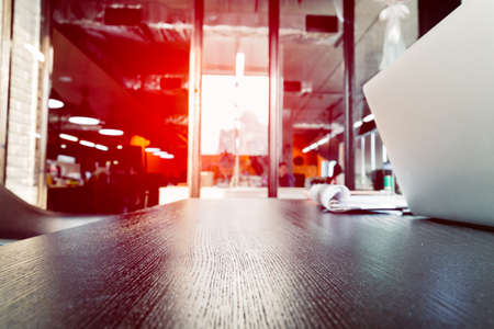 Office table background ideas and business concept. Side view of empty working table in black wood and computer  laptop with copy space.の写真素材