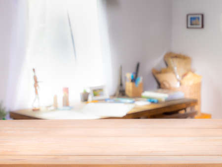 Wooden table top on defocused a diy craft book on table with curtain window and stationery box. - Using for Mock up template for display of your design,Banner for advertise of product.の写真素材