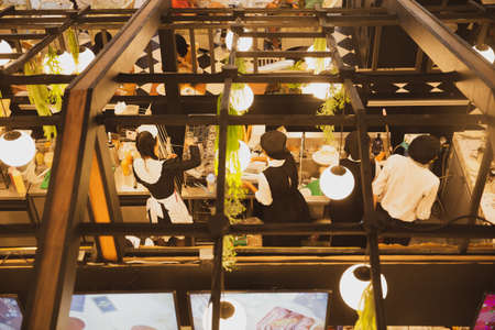 Top view of chefs and staff  working in the open kitchen in modern restaurant.の写真素材