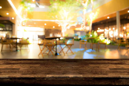 Real wood table with appetizer and light reflection on scene at restaurant, pub or bar at night. Blurred background for product display or montage your products with several concept idea and any occasion.の写真素材