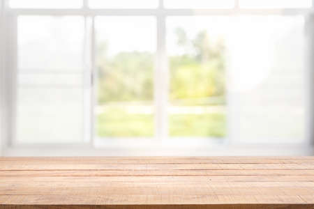 Blur background of white window glass and green view from garden with epty of wood table. Using for Mock up template for craft display of your design,Banner for advertise of product.の写真素材
