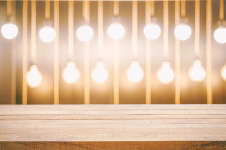 Empty wood table top and blur of Yellow light and bokeh in night time. Using for Mock up template for craft display of your design,Banner for advertise of product.の写真素材