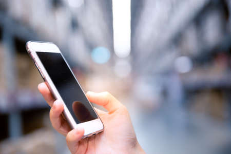 Close up of female hands using smart phone at the office, searching or social networks concept, hipster lady typing an sms message. Copy space for text and background concept.の写真素材
