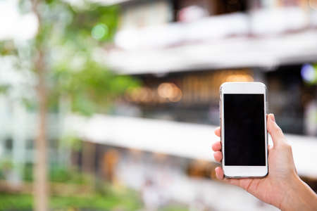 A female hand holding mobile phone. Copy space for text and background concept.の写真素材